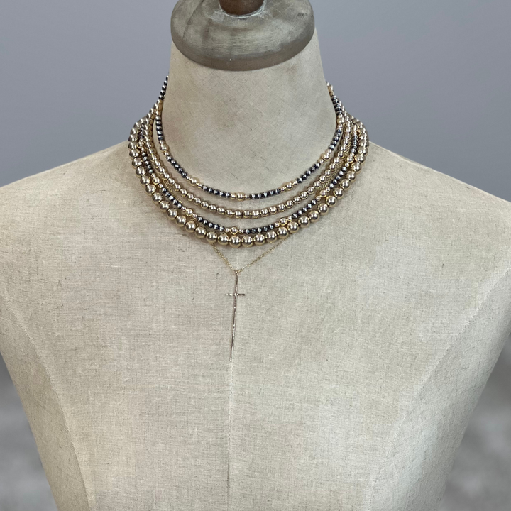 Necklace on a mannequin with a gray background