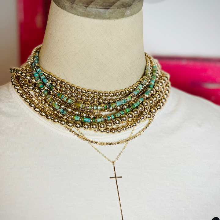 Gold and Turquoise necklaces on mannequin