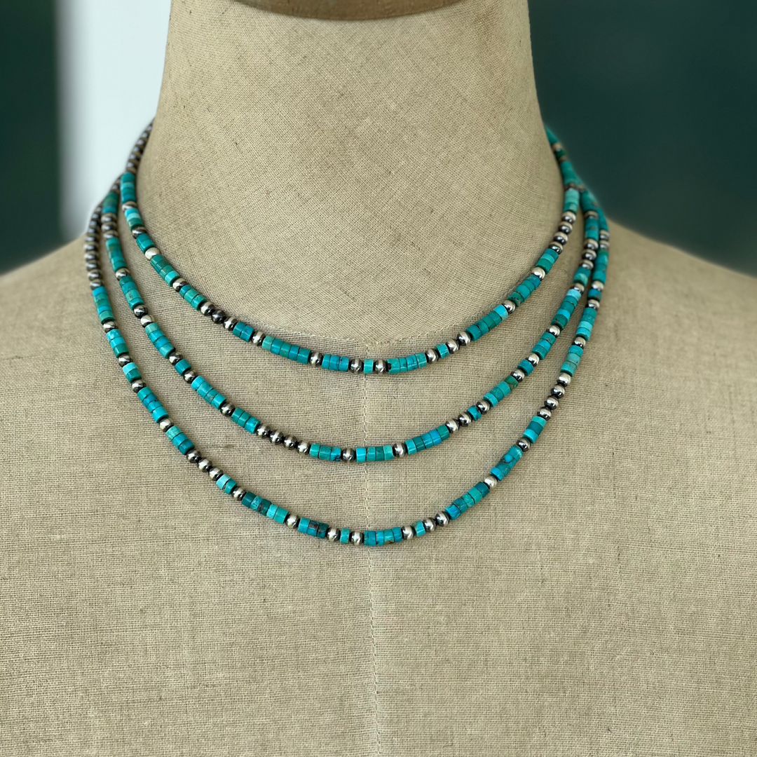 Turquoise and sterling silver beaded necklaces on mannequin