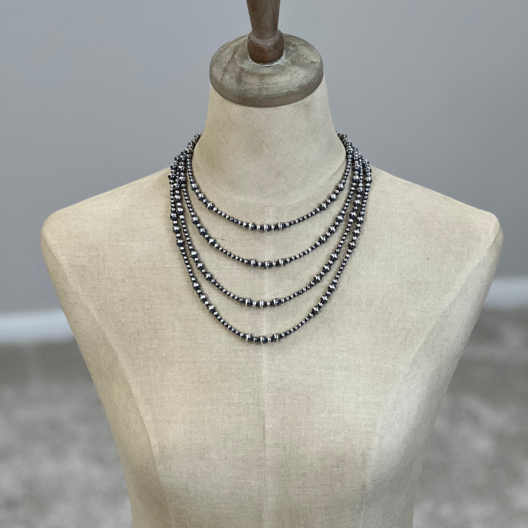 Sterling silver Necklaces on a mannequin with a neutral background