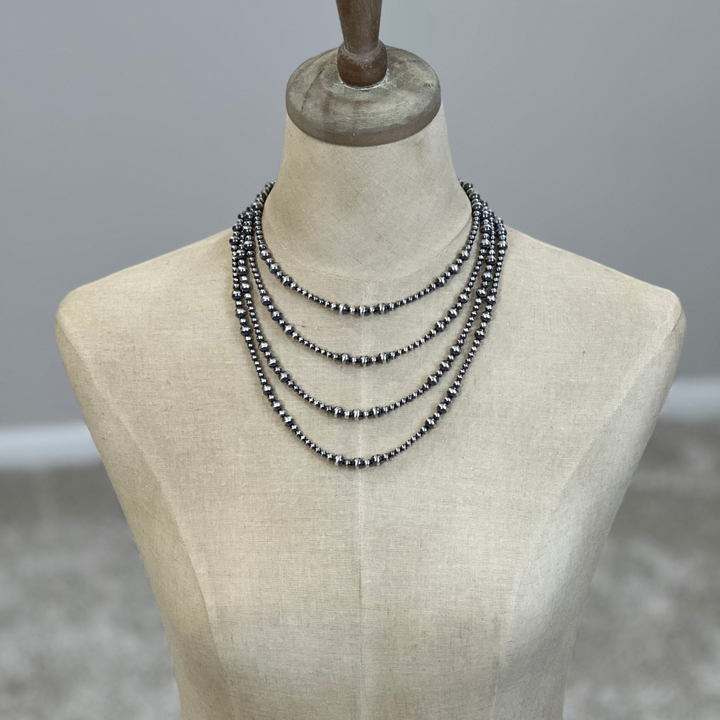 Sterling silver Necklaces on a mannequin with a neutral background