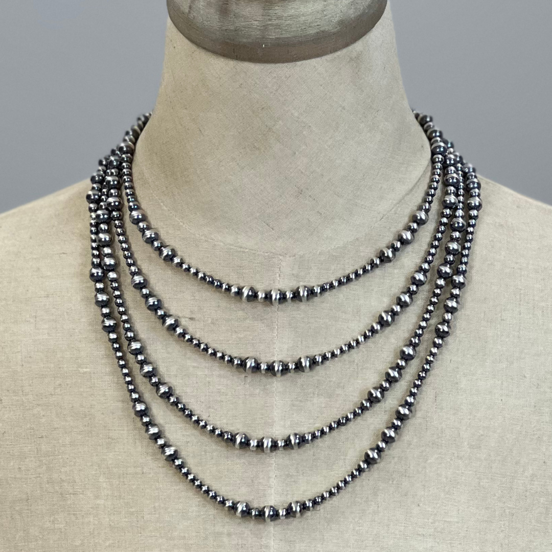 Sterling silver beaded necklace on a mannequin with a neutral background