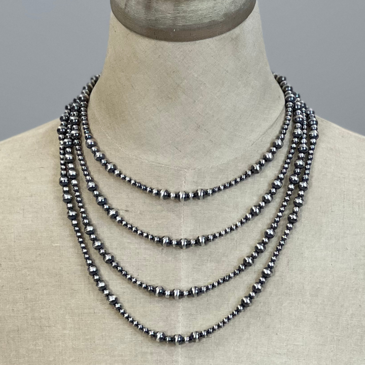 Sterling silver beaded necklace on a mannequin with a neutral background